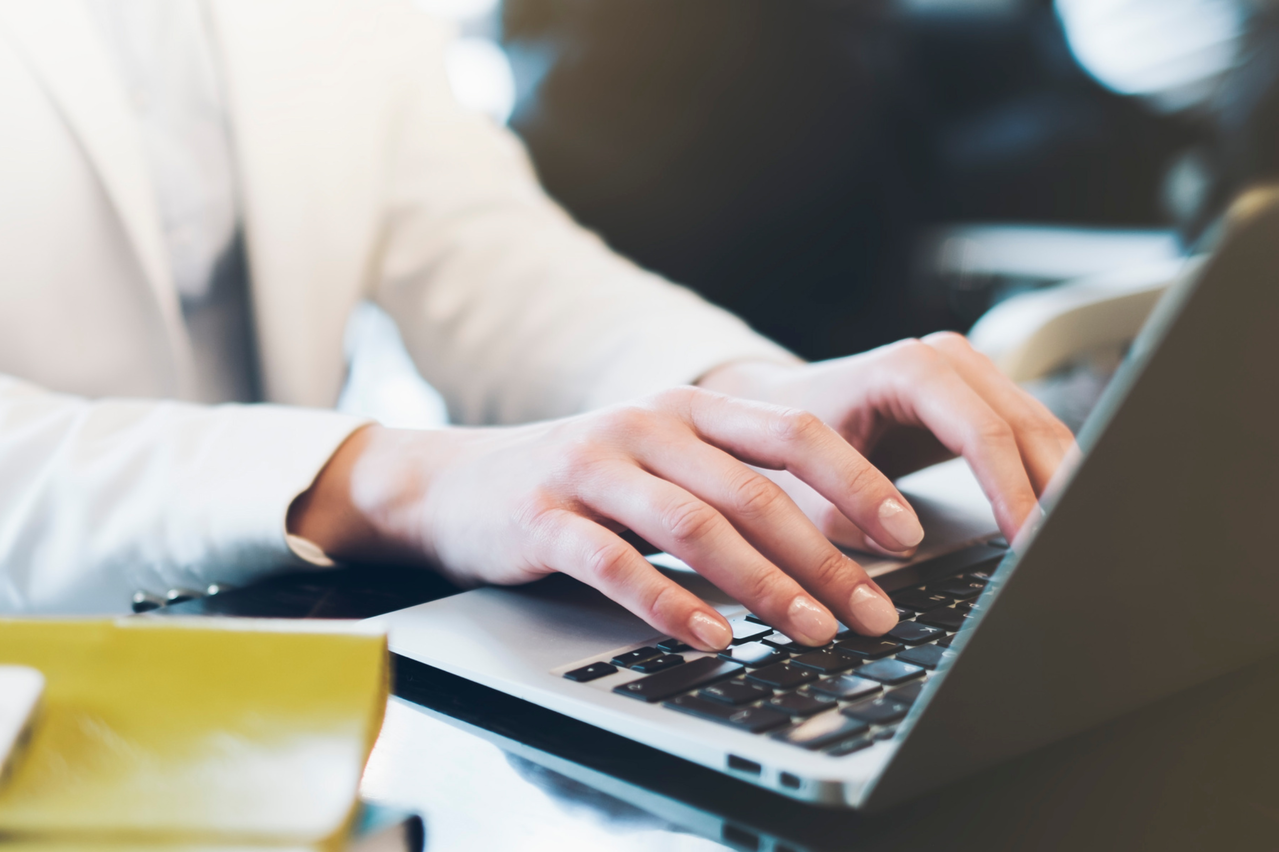 Fingers typing on a laptop keyboard. 