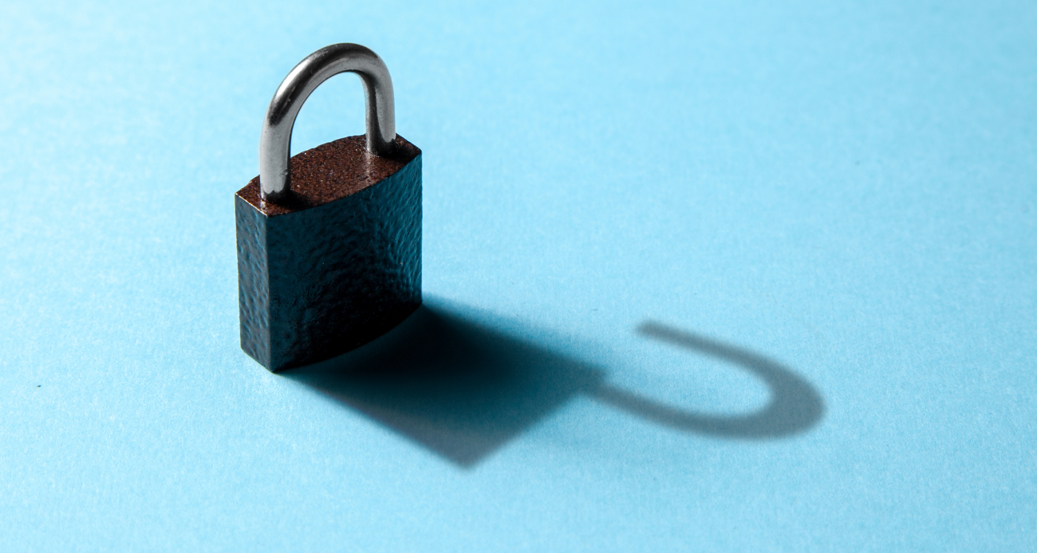 An closed padlock, casting a shadow of an open padlock