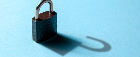 An closed padlock, casting a shadow of an open padlock