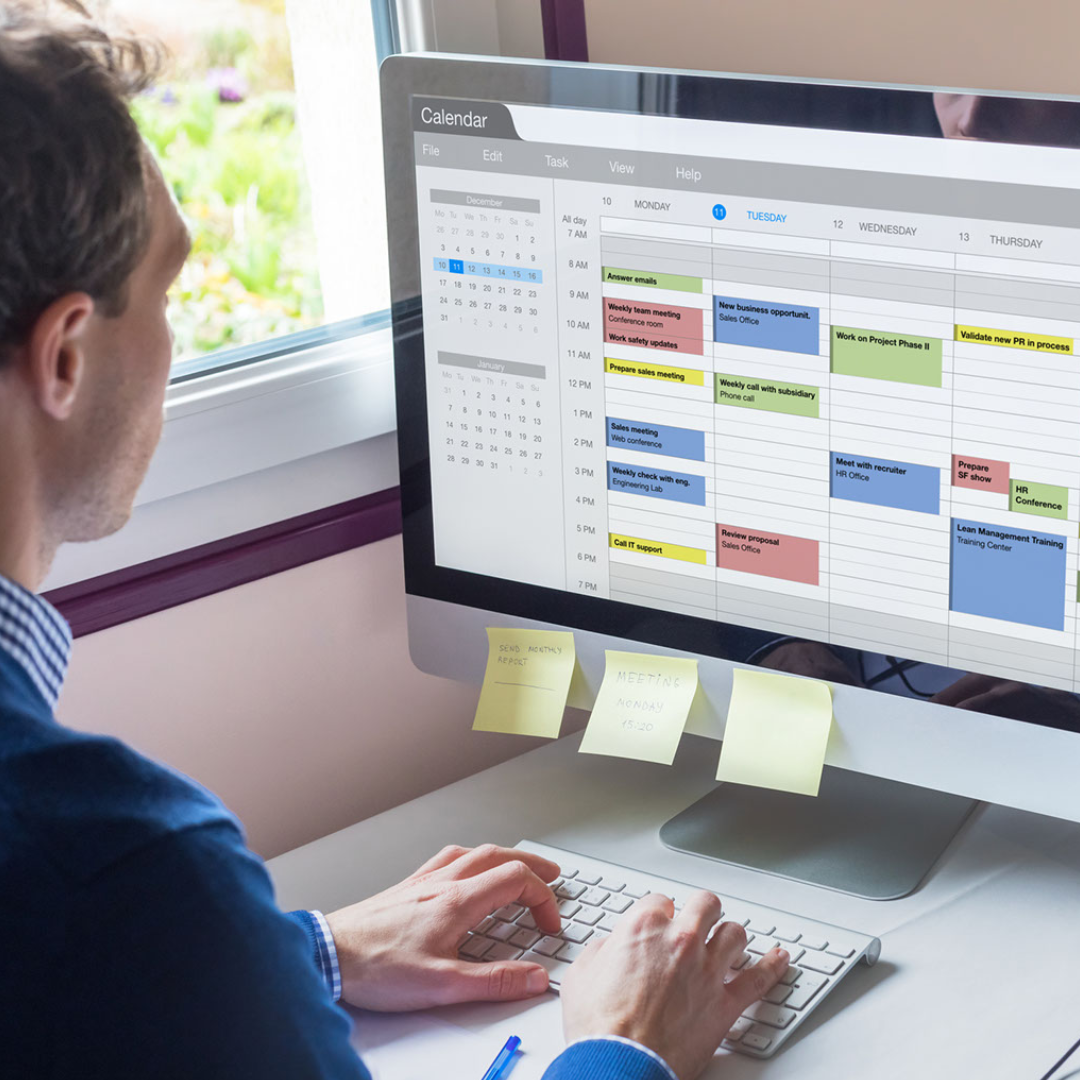 A person looking at a screen of calendar appointments.