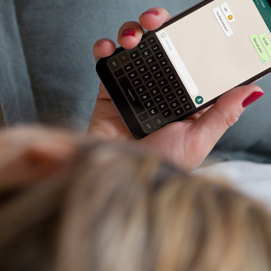 A person reads a message on a smartphone. 