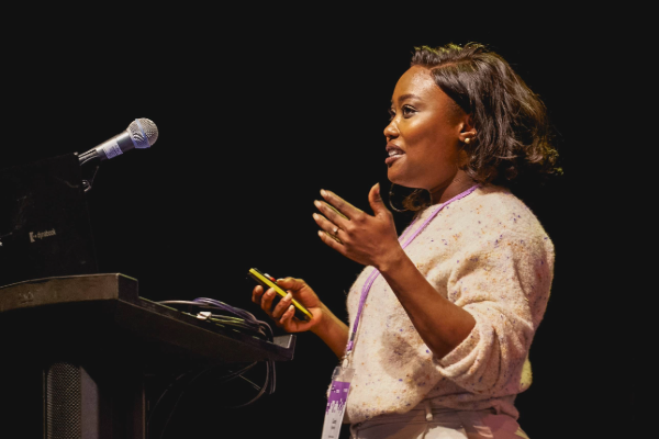 Camp Digital 2024 speaker Candy Ogbebor onstage delivering a lightning talk during 300 Seconds