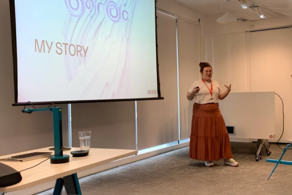 Molly Watt giving a presentation on accessibility at Auto Trader 