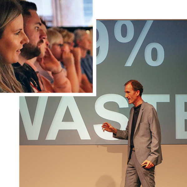 Two hexagon shaped photographs with a smaller picture slightly overlaid by a larger picture. In the small picture, people are sat in an audience, smiling. In the larger picture, a white man is walking in the middle of a stage, surrounded by an audience.