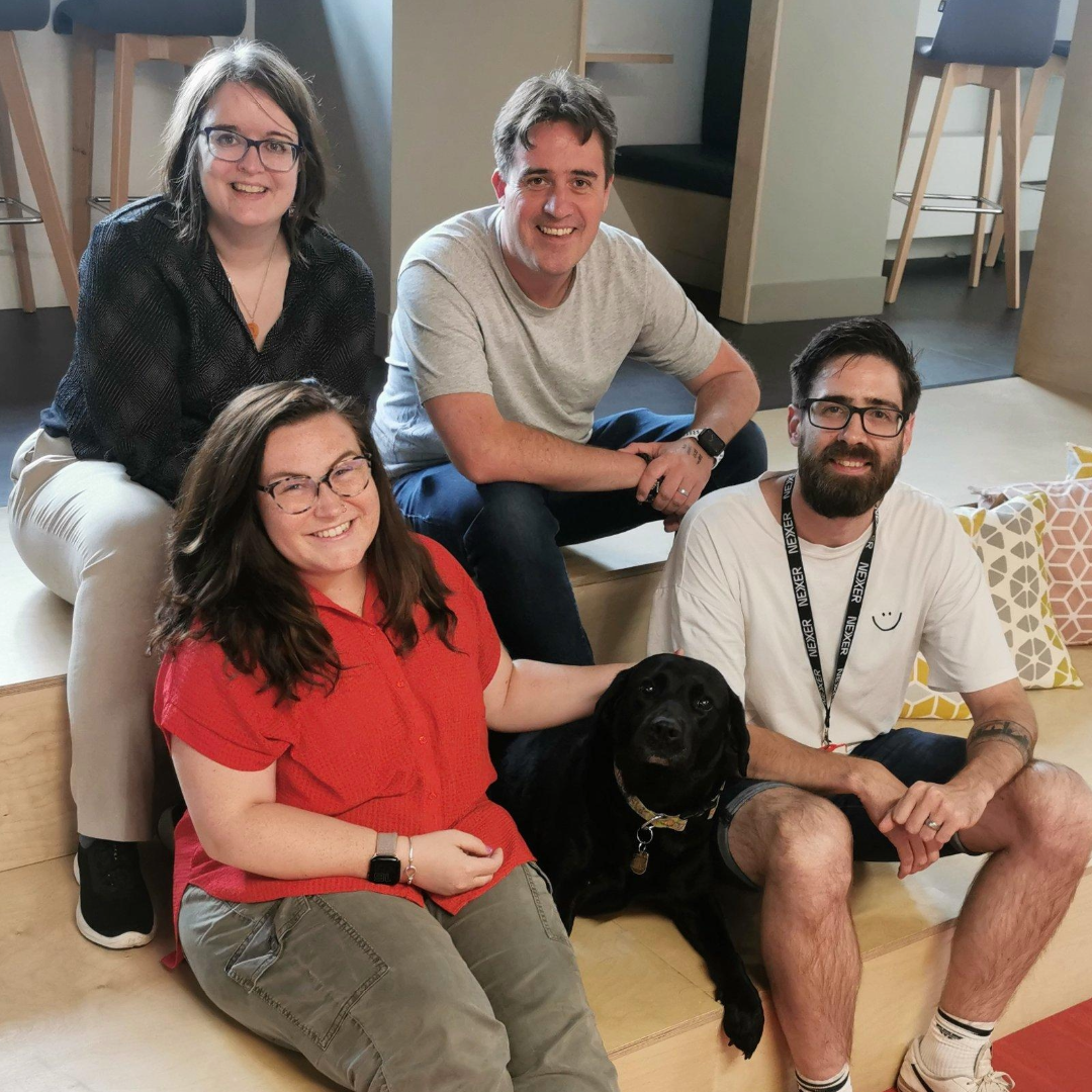 Emma, Chris, Danny, Molly, and Bella the guide dog from the Nexer accessibility team