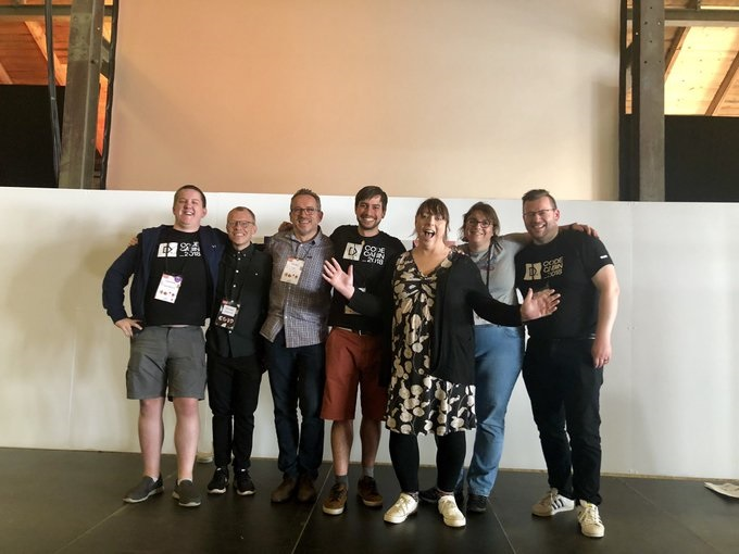 The Umbraco accessibilty team at the Codegarden 2019 conference. The group are white people stood in a line against a white wall. They are all smiling and happy. 
