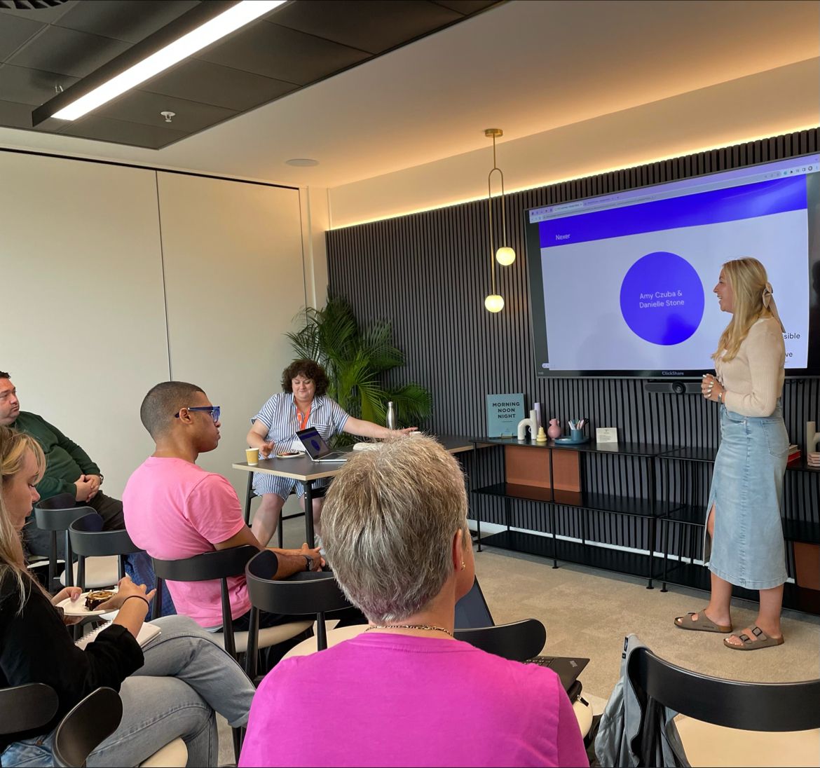 Nexer's Amy Czuba delivers a presentation to a crowded meeting room at the RTC meetup