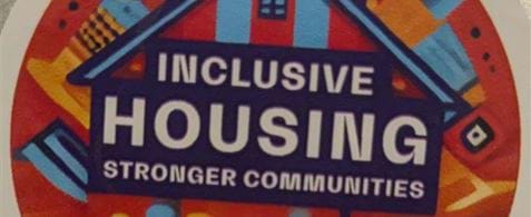 A sticker stuck on a laptop, which reads "Inclusive housing. Stronger Communities. Nexer and Paper 2025"