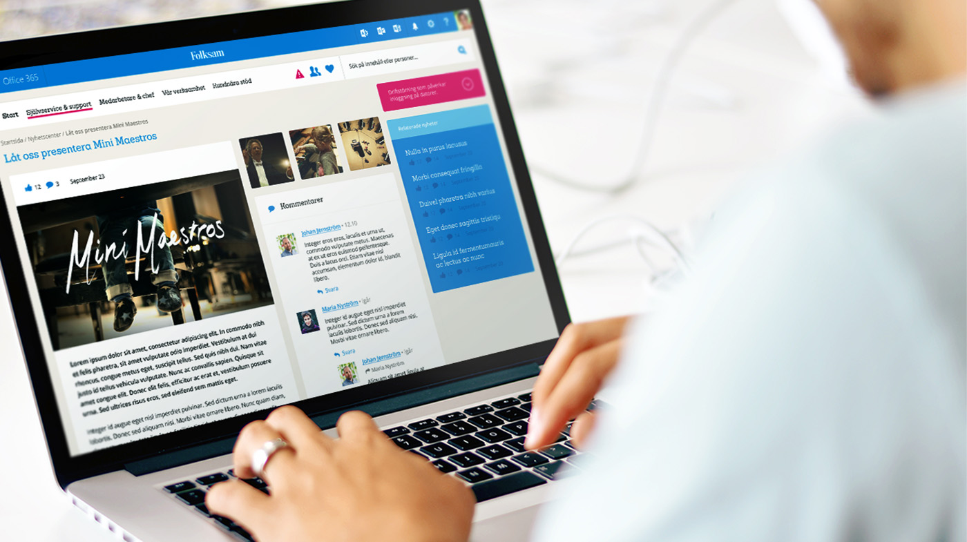 A laptop showing the Folksam intranet with a user's hands on the keyboard
