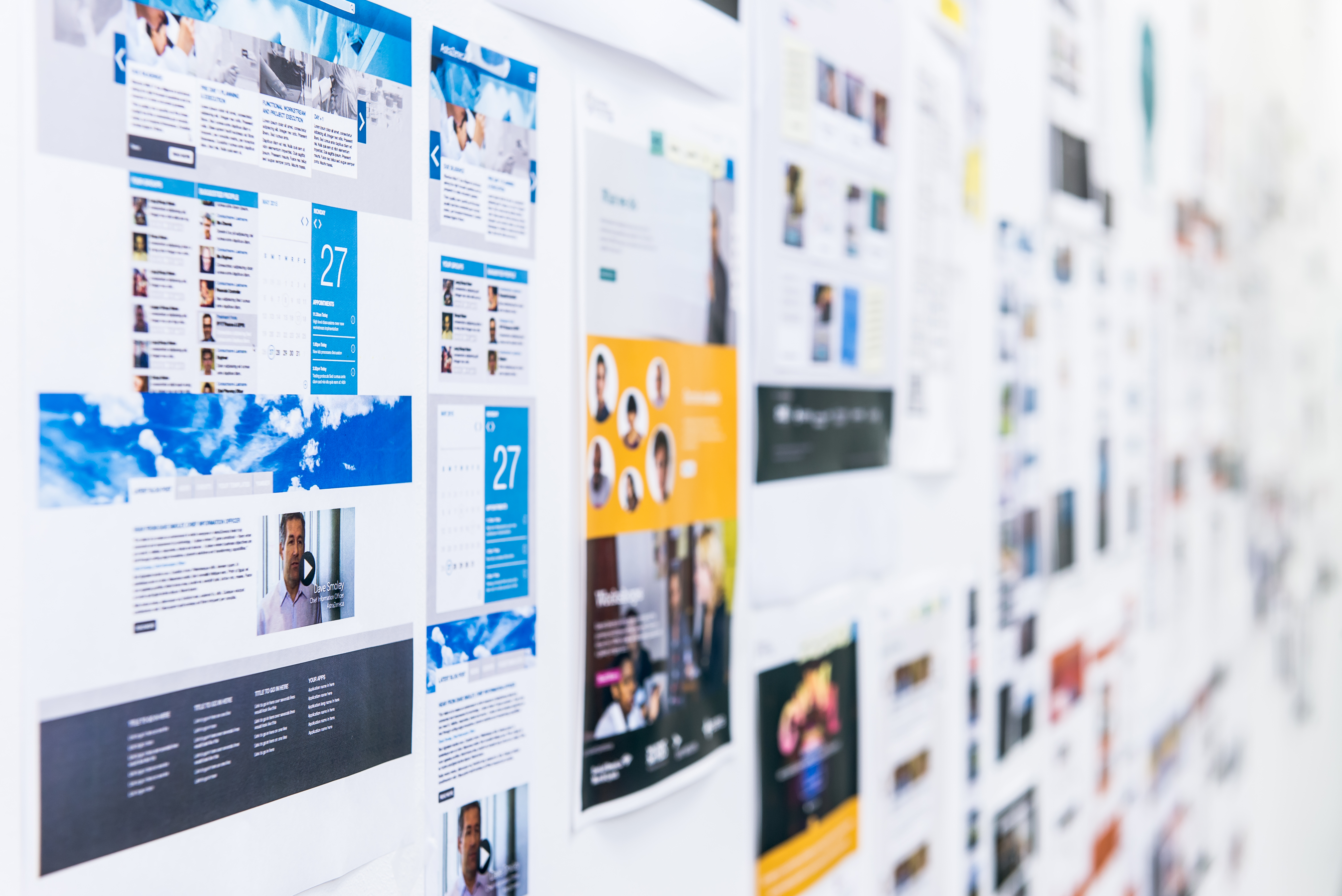 A wall with printed out screenshots of lots of websites. 