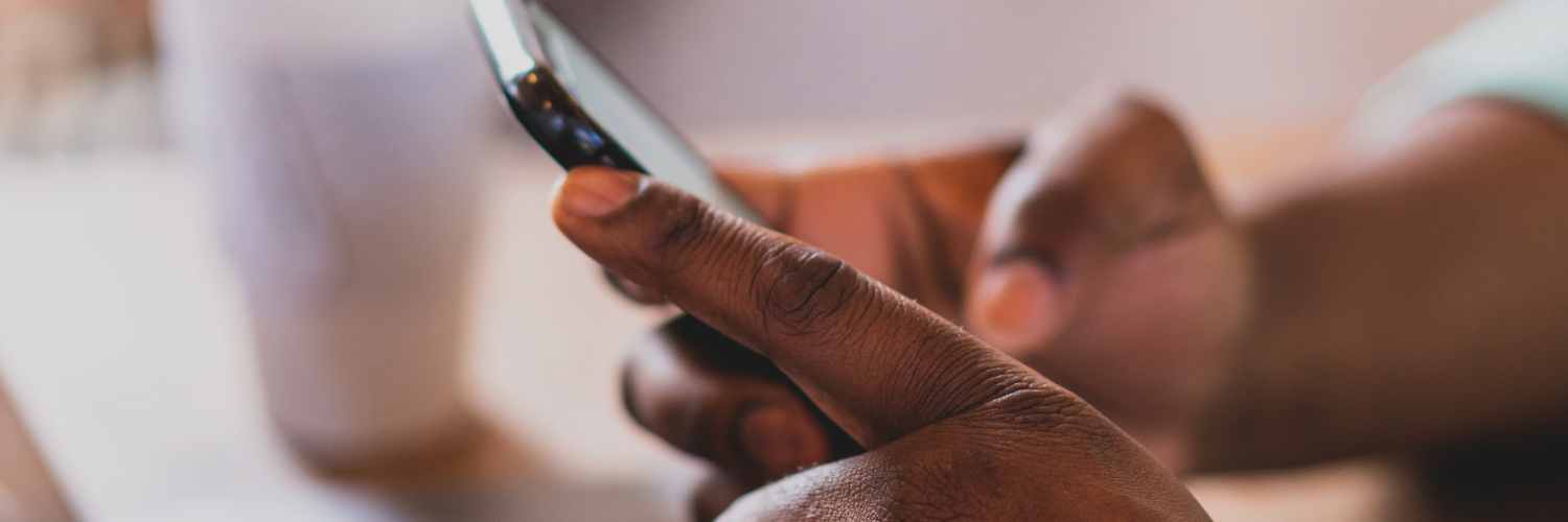 A pair of hands typing on a mobile phone
