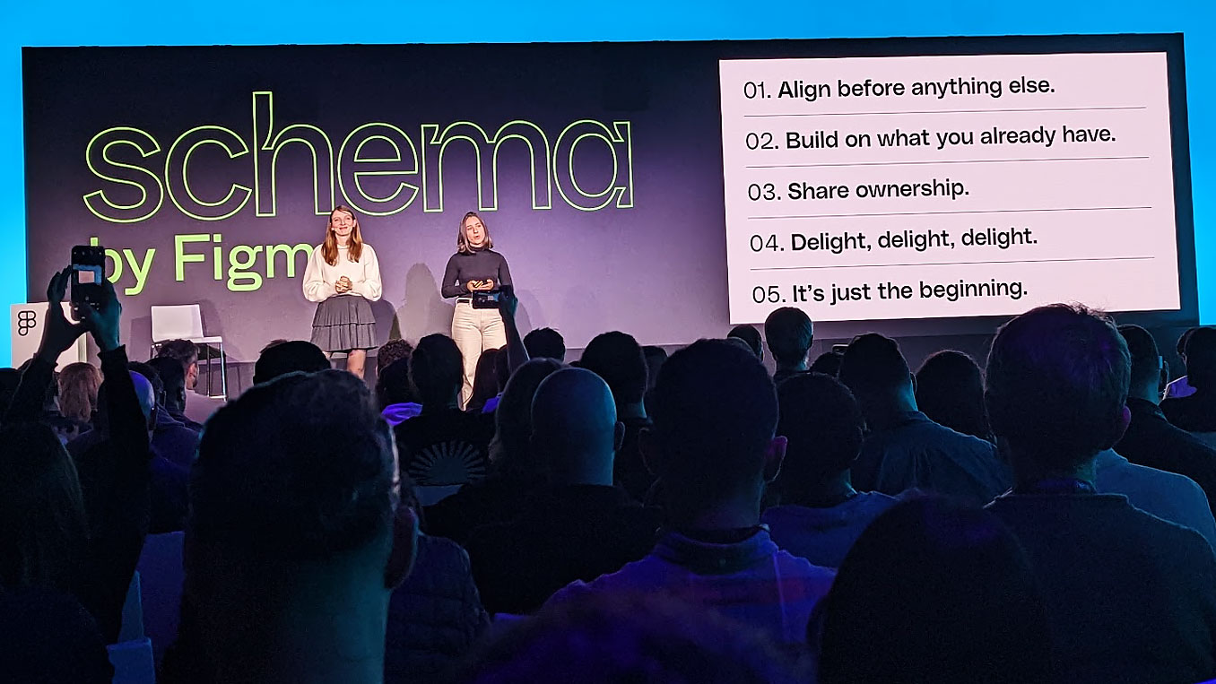 An audience seated watching a talk by Gabrielle Houeix and Marion Echevard