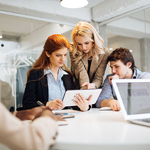 Group of people around an ipad